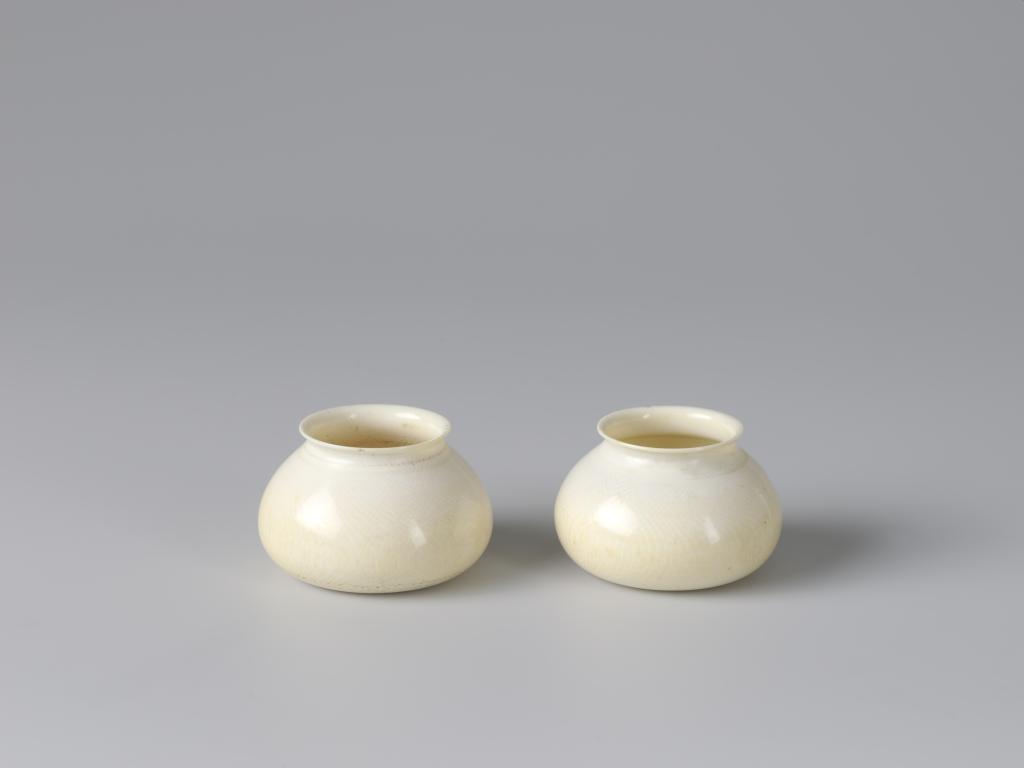 A pair of Chinese turned ivory scholar’s brush pots