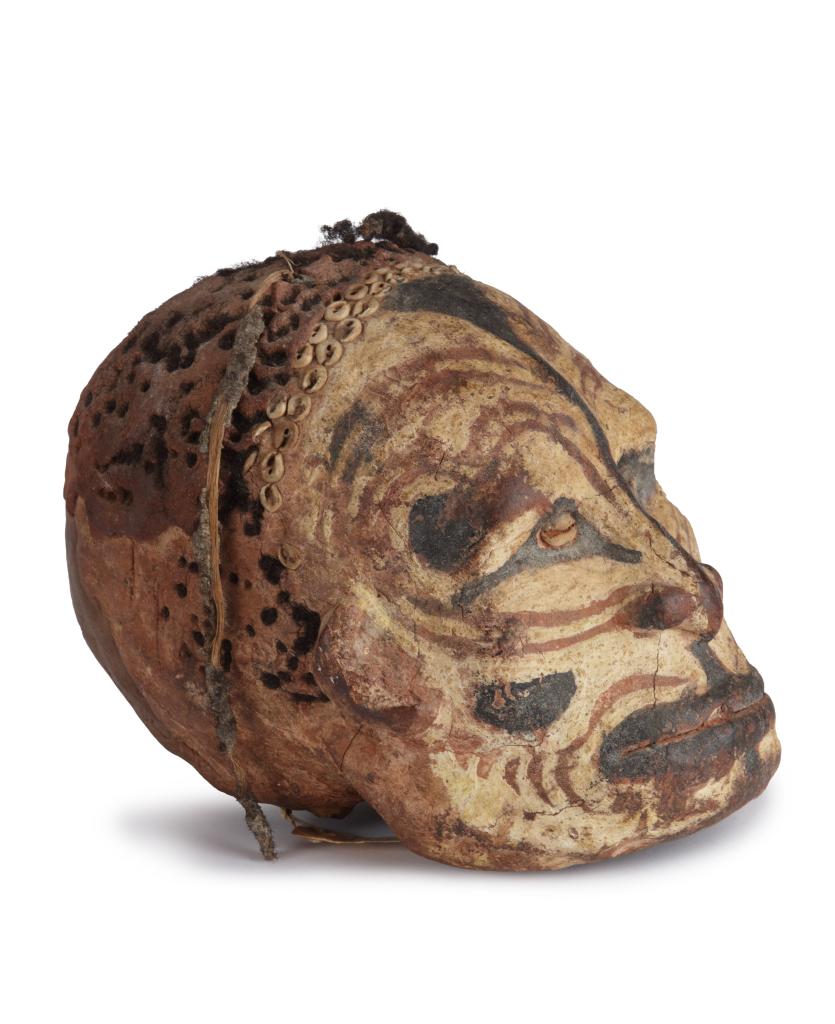 A Sepik shell-and-pigment decorated clay overmodeled ancestral skull