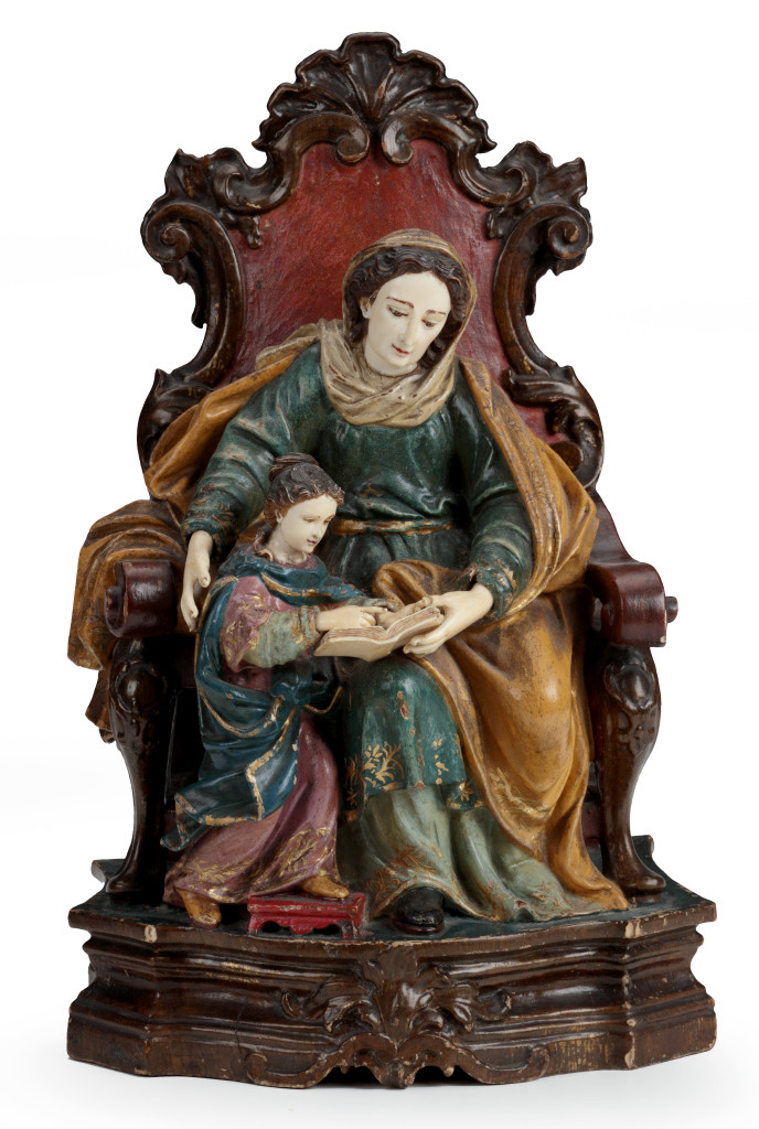 An Indian-Portuguese wood and ivory sculpture of the Madonna seated on a throne, giving Jesus reading lessons
